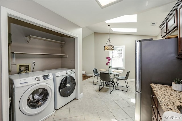 9286 Hungary Rd, Glen Allen, VA 23060 - laundry area with a skylight, light tile patterned flooring, and washer and clothes dryer