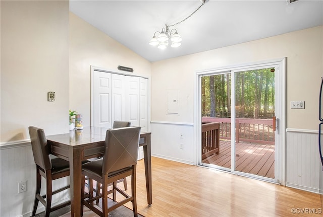 2705 Glen Point Cir, Henrico, VA 23233 - dining space with light wood-style floors, a chandelier, lofted ceiling, electric panel, and a wainscoted wall