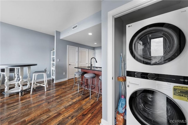1101 Haxall Pt Unit U712, Richmond, VA 23219 - washroom featuring estacked washer and dryer, dark wood finished floors, and recessed lighting