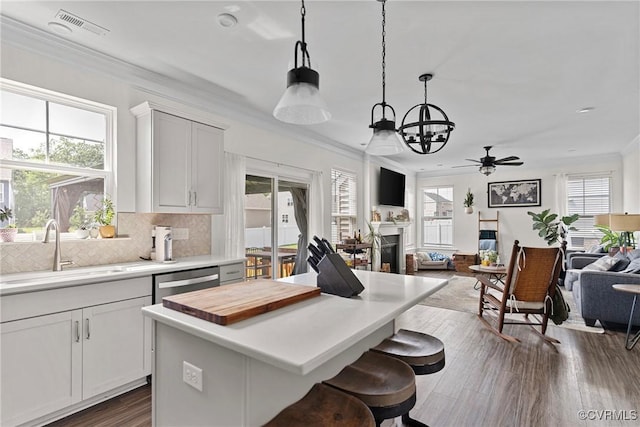 7012 Hapsburg Ct, Henrico, VA 23231 - kitchen with ornamental molding, dark wood-style floors, open floor plan, a ceiling fan, and a chandelier