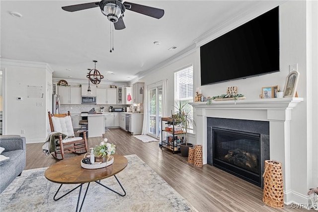 7012 Hapsburg Ct, Henrico, VA 23231 - living room with ornamental molding, a glass covered fireplace, a ceiling fan, and wood finished floors