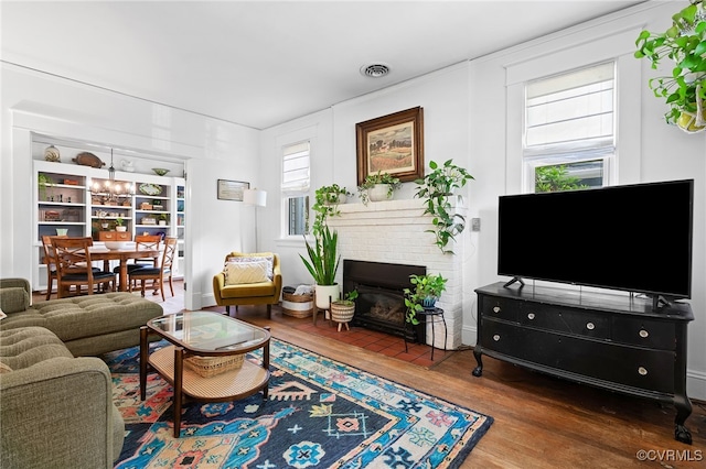 4006 Chevy Chase St, Richmond, VA 23227 - living area featuring wood finished floors, a fireplace, and a chandelier