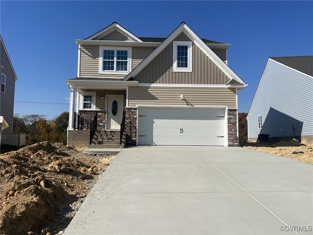 4913 Bailey Woods Ln, Midlothian, VA 23112 - view of front of home featuring stone siding, driveway, board and batten siding, and a garage