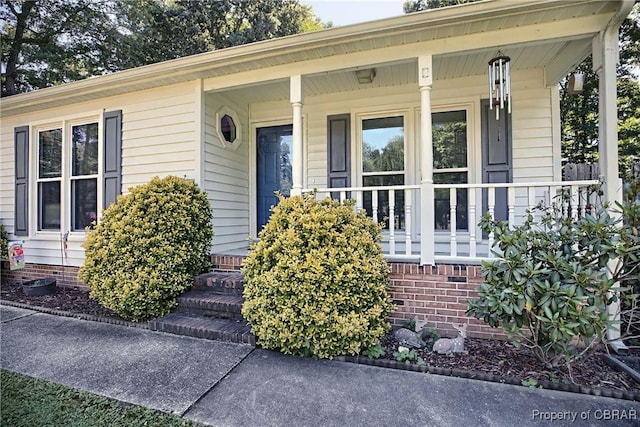 8187 Lord Fairfax Cir, Gloucester, VA 23061 - doorway to property featuring a porch