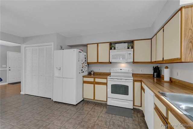 8187 Lord Fairfax Cir, Gloucester, VA 23061 - kitchen with white appliances, light tile patterned floors, and light countertops