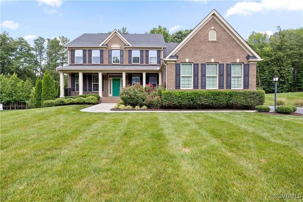 11513 Emerson Mill Way, Glen Allen, VA 23059 - view of front of house with brick siding, a front yard, and a porch
