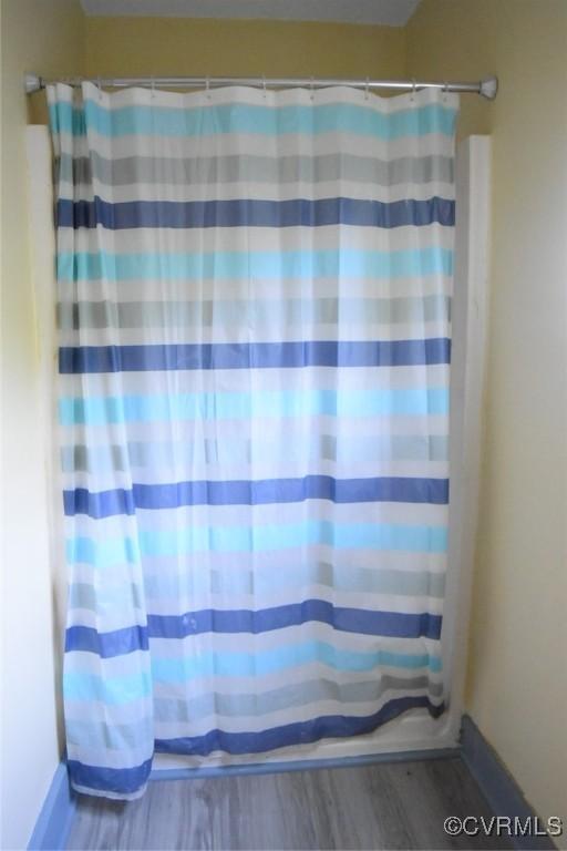 1642 Free State Rd, Meherrin, VA 23954 - bathroom featuring wood finished floors and curtained shower