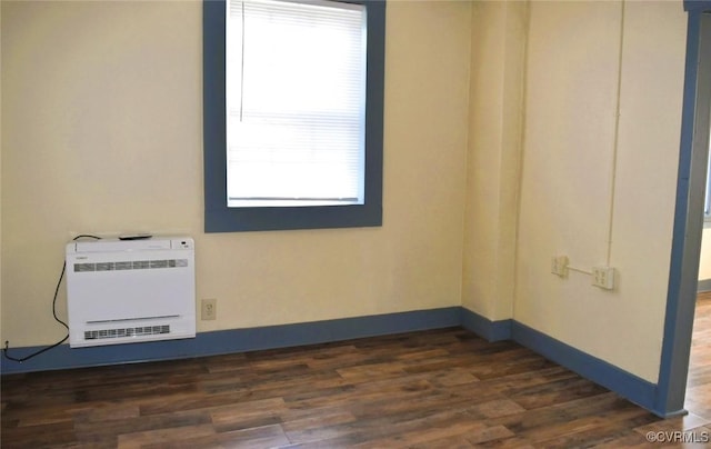 1642 Free State Rd, Meherrin, VA 23954 - empty room featuring heating unit, healthy amount of natural light, and dark wood-style flooring