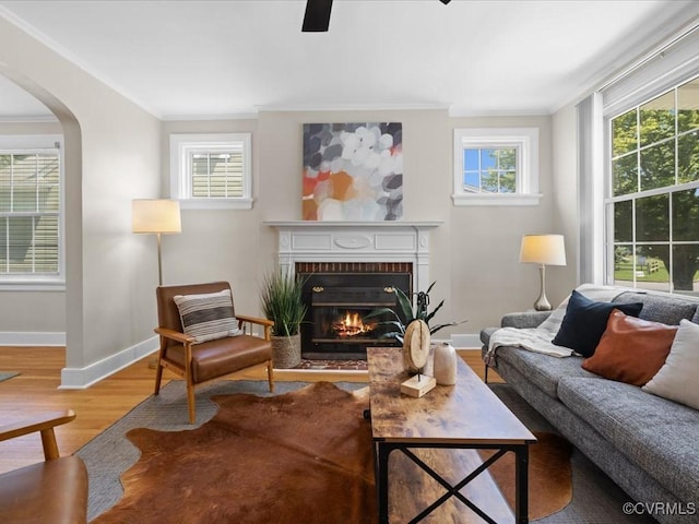 3303 Woodrow Ave, Richmond, VA 23222 - living area with ornamental molding, wood finished floors, a brick fireplace, arched walkways, and ceiling fan
