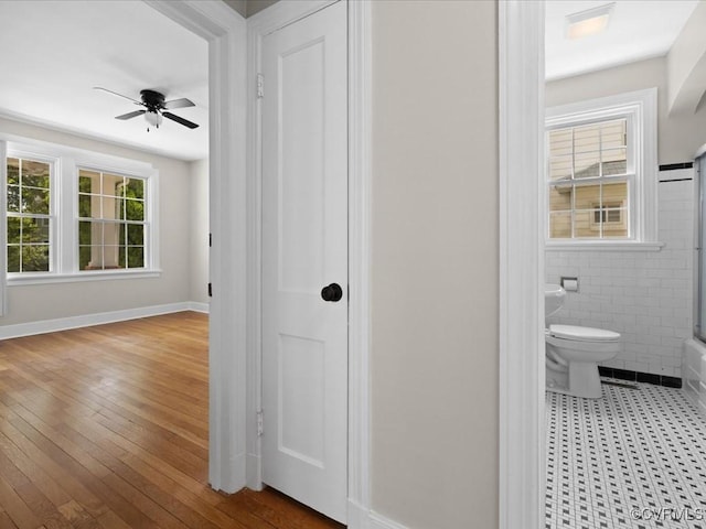 3303 Woodrow Ave, Richmond, VA 23222 - hallway with wood-type flooring and tile walls