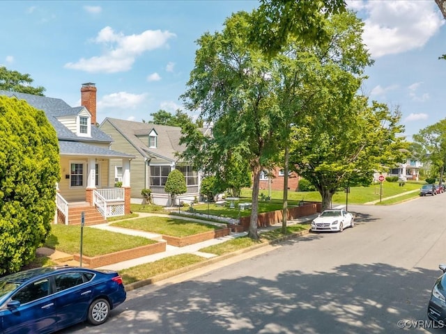 3303 Woodrow Ave, Richmond, VA 23222 - view of front of house with a chimney, a front lawn, and roof with shingles
