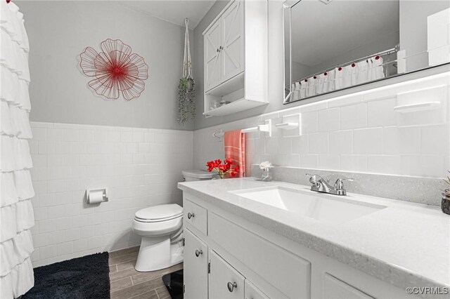 1200 Hybla Rd, Richmond, VA 23236 - full bathroom featuring tile walls, wood finished floors, vanity, and wainscoting