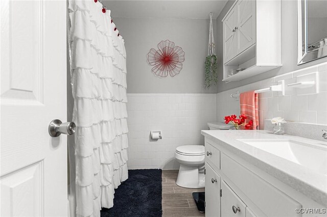 1200 Hybla Rd, Richmond, VA 23236 - full bathroom with tile walls, vanity, wood finished floors, and wainscoting