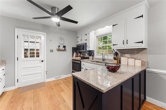 1200 Hybla Rd, Richmond, VA 23236 - kitchen with stainless steel appliances, white cabinetry, light wood-style flooring, and a peninsula