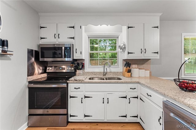 1200 Hybla Rd, Richmond, VA 23236 - kitchen with stainless steel appliances, white cabinets, light stone countertops, and decorative backsplash