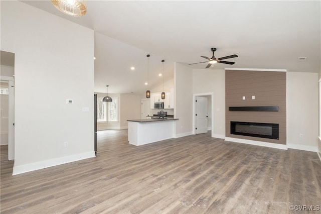 TBD Union Church Rd, Beaverdam, VA 23015 - unfurnished living room featuring a ceiling fan, high vaulted ceiling, light wood-style flooring, and a large fireplace