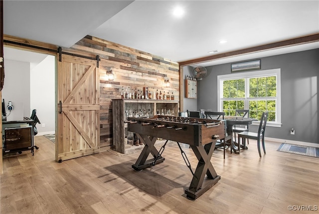 14942 Bridge Spring Dr, Midlothian, VA 23113 - recreation room featuring wooden walls, a barn door, wood finished floors, and recessed lighting