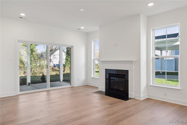 124 Steyland St, Ashland, VA 23005 - unfurnished living room featuring wood finished floors, a glass covered fireplace, and recessed lighting