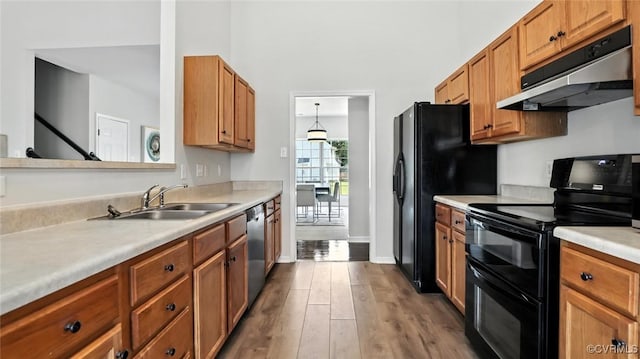 3208 Warm Springs Way, Henrico, VA 23223 - kitchen featuring black appliances, under cabinet range hood, light countertops, wood finished floors, and brown cabinets