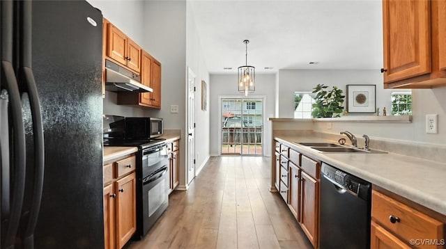 3208 Warm Springs Way, Henrico, VA 23223 - kitchen featuring black appliances, under cabinet range hood, light countertops, light wood-type flooring, and brown cabinets