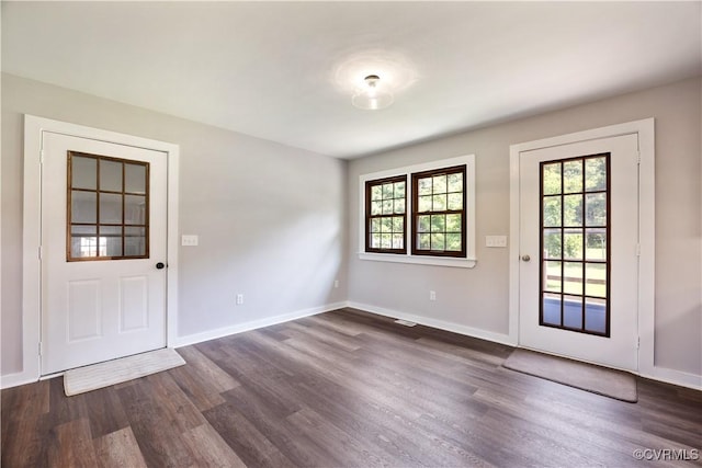 10324 Lamore Dr, Disputanta, VA 23842 - doorway with dark wood-style floors and baseboards