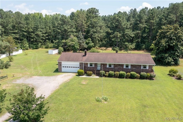 10324 Lamore Dr, Disputanta, VA 23842 - ranch-style home featuring a garage, dirt driveway, a front yard, a chimney, and a view of trees