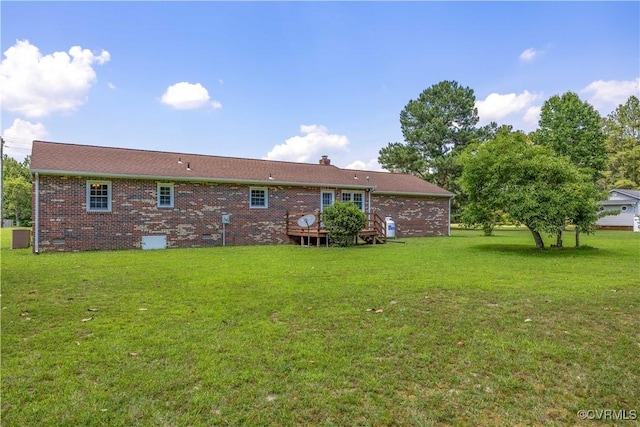 10324 Lamore Dr, Disputanta, VA 23842 - rear view of house with a lawn, brick siding, crawl space, a wooden deck, and a chimney