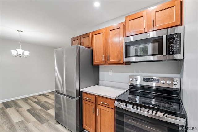 6512 N Stevens Hollow Dr, Chesterfield, VA 23832 - kitchen featuring stainless steel appliances, a chandelier, light wood-type flooring, light countertops, and pendant lighting