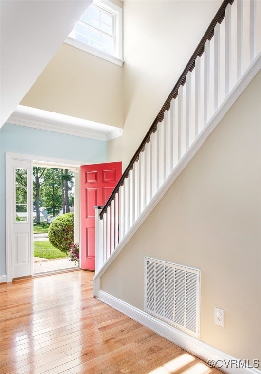 1204 Bowden Rd, Henrico, VA 23229 - foyer entrance with a towering ceiling, hardwood / wood-style flooring, crown molding, and stairway
