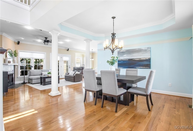 1204 Bowden Rd, Henrico, VA 23229 - dining room featuring decorative columns, light wood-style flooring, a fireplace with flush hearth, a chandelier, and crown molding