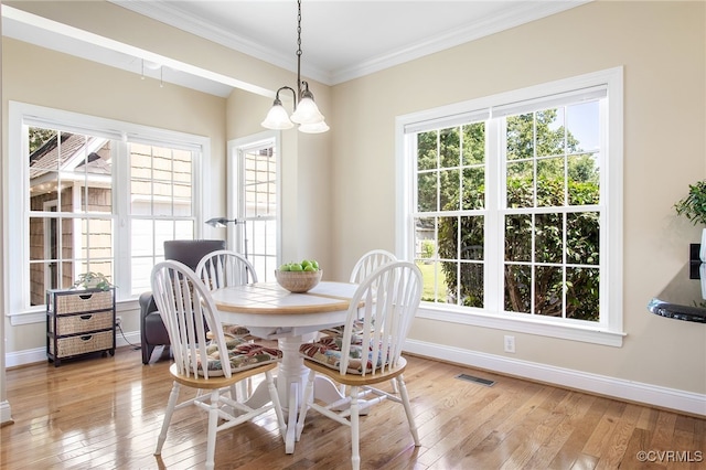 1204 Bowden Rd, Henrico, VA 23229 - dining area featuring light wood finished floors, ornamental molding, and a chandelier