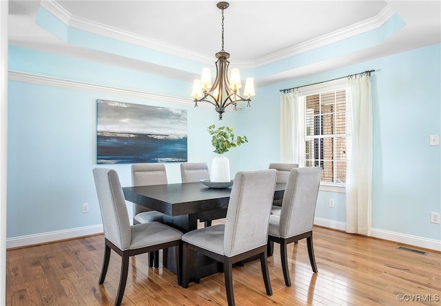 1204 Bowden Rd, Henrico, VA 23229 - dining space featuring a chandelier, light wood-style floors, crown molding, and a raised ceiling