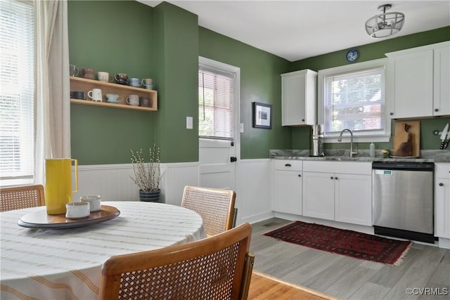 202 Larne Ave, Richmond, VA 23224 - kitchen featuring dishwasher, a wainscoted wall, healthy amount of natural light, light wood-type flooring, and white cabinetry