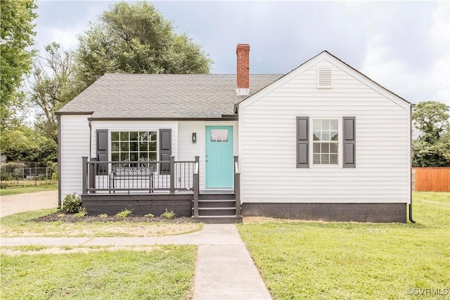 25713 Simmons Ave, North Dinwiddie, VA 23803 - view of front facade featuring a chimney, roof with shingles, and a porch