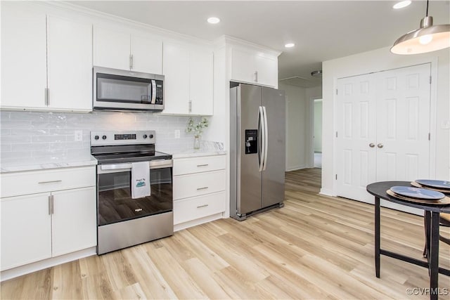 25713 Simmons Ave, North Dinwiddie, VA 23803 - kitchen with appliances with stainless steel finishes, white cabinetry, tasteful backsplash, light wood-style floors, and recessed lighting