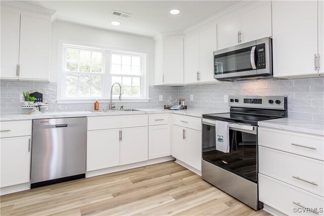 25713 Simmons Ave, North Dinwiddie, VA 23803 - kitchen featuring stainless steel appliances, white cabinets, decorative backsplash, and recessed lighting