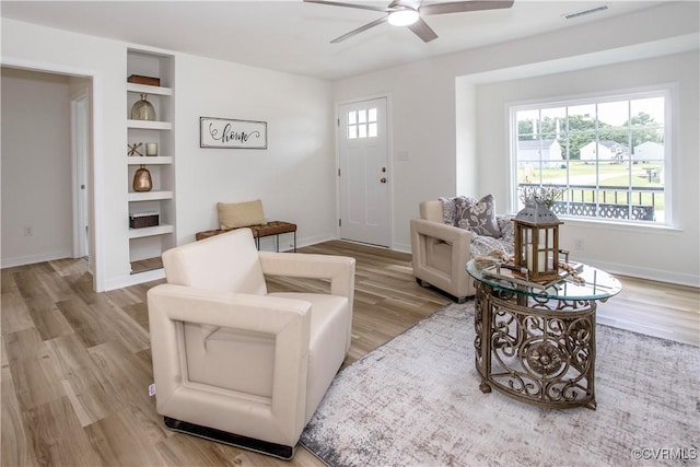 25713 Simmons Ave, North Dinwiddie, VA 23803 - living room with a ceiling fan, wood finished floors, and built in features