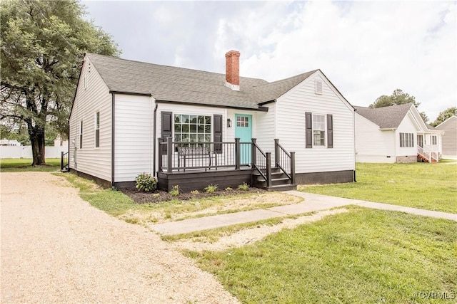 25713 Simmons Ave, North Dinwiddie, VA 23803 - view of front facade with a chimney, a front lawn, and a shingled roof