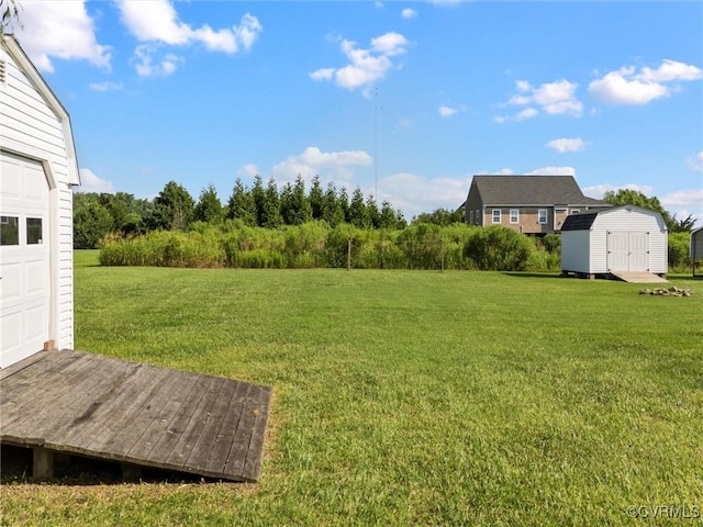 621 Fort Lowry Ln, Dunnsville, VA 22454 - view of grassy yard featuring a storage shed and a garage