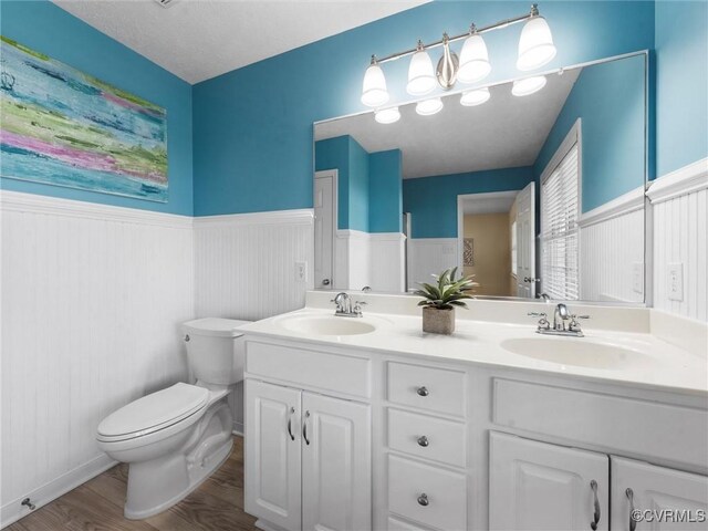 621 Fort Lowry Ln, Dunnsville, VA 22454 - full bath with a wainscoted wall, wood finished floors, and double vanity