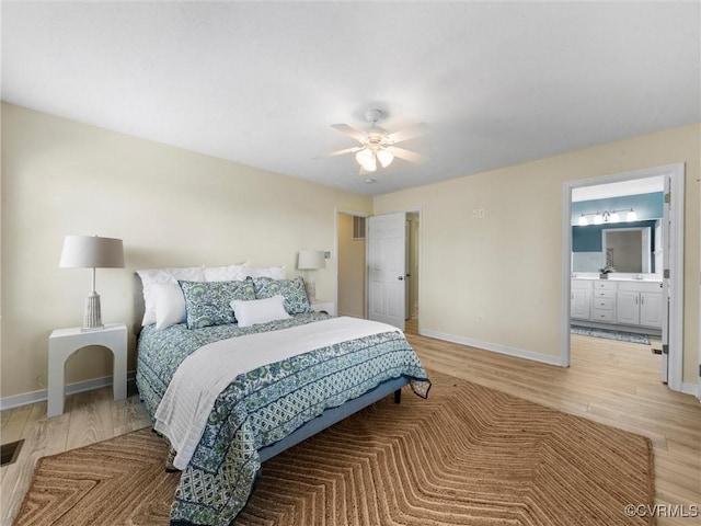 621 Fort Lowry Ln, Dunnsville, VA 22454 - bedroom featuring light wood-style floors, ensuite bath, and a ceiling fan