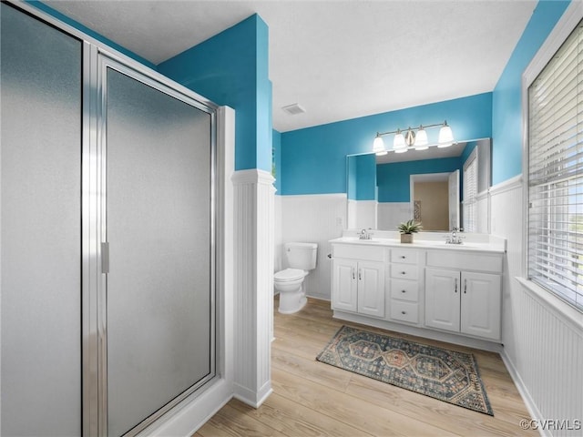 621 Fort Lowry Ln, Dunnsville, VA 22454 - full bath featuring double vanity, wood finished floors, a shower stall, and a wainscoted wall