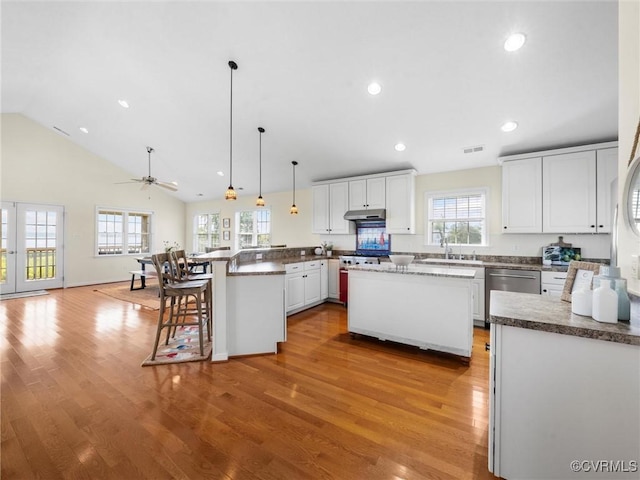 621 Fort Lowry Ln, Dunnsville, VA 22454 - kitchen with dishwasher, a peninsula, light wood-style flooring, white cabinets, and recessed lighting