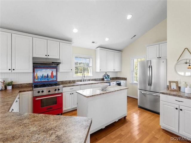 621 Fort Lowry Ln, Dunnsville, VA 22454 - kitchen with stainless steel appliances, under cabinet range hood, white cabinets, lofted ceiling, and light wood-style flooring