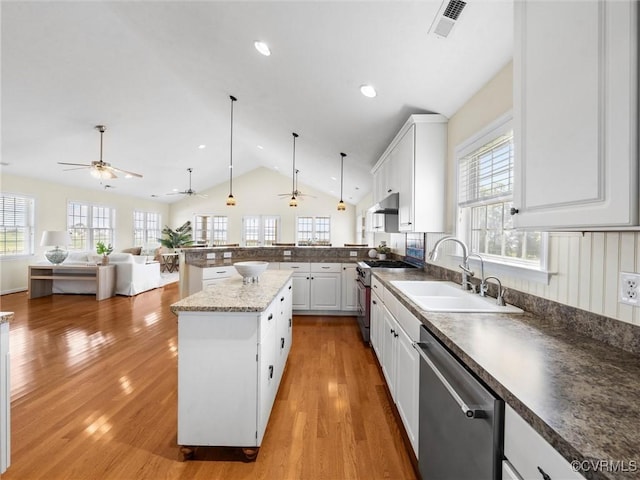 621 Fort Lowry Ln, Dunnsville, VA 22454 - kitchen with appliances with stainless steel finishes, lofted ceiling, a peninsula, open floor plan, and light wood finished floors