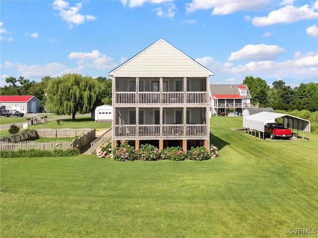 621 Fort Lowry Ln, Dunnsville, VA 22454 - rear view of house featuring a carport, a yard, and a sunroom
