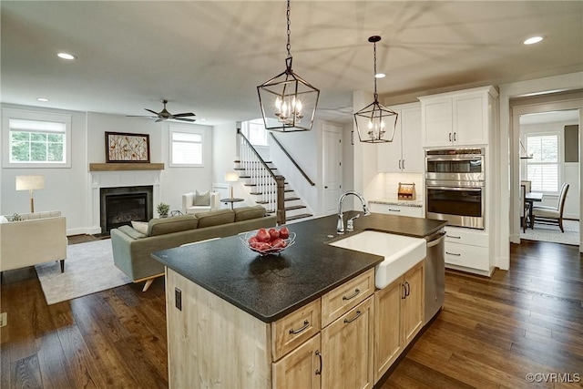 2500 Madison Station Ct, Henrico, VA 23233 - kitchen with appliances with stainless steel finishes, a ceiling fan, dark wood-style flooring, a fireplace with flush hearth, and recessed lighting