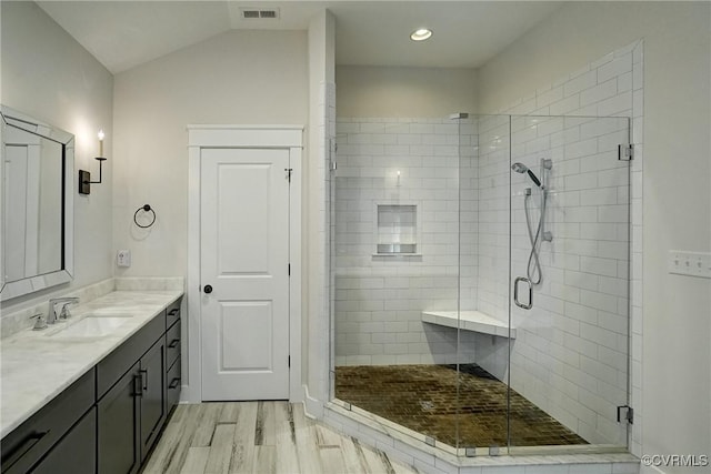2500 Madison Station Ct, Henrico, VA 23233 - bathroom featuring vanity, a shower stall, wood finished floors, vaulted ceiling, and recessed lighting