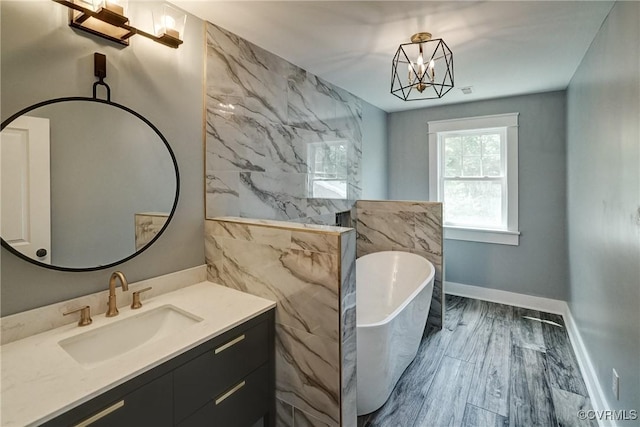 2500 Madison Station Ct, Henrico, VA 23233 - bathroom featuring a freestanding bath, vanity, and a chandelier