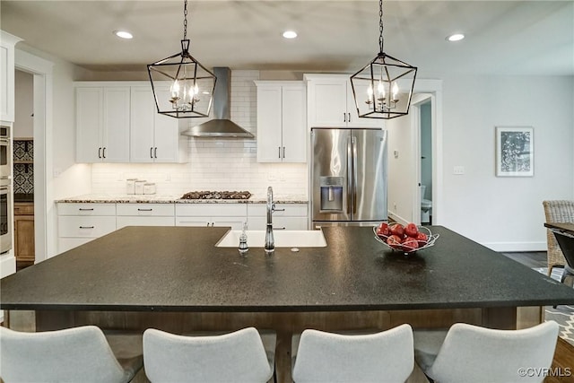 2500 Madison Station Ct, Henrico, VA 23233 - kitchen featuring appliances with stainless steel finishes, a chandelier, wall chimney exhaust hood, decorative backsplash, and recessed lighting